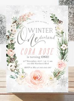 the winter wonderland coral rose birthday party is on display in front of a wooden table