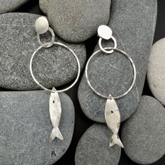 "This beautiful pair of earrings is composed by little silver fishes and rings. Thanks to its lightness, the various pieces have a great capacity of movement. Very easy to wear,capable of giving you a natural and rustic touch. I hammered them piece by piece, to give you all the most unique result! This piece is entirely made by myself, soldering sterling silver (925) with traditional Jewelry techniques. Every piece is unique! Dimensions: Lenght: 3.18\" 81mm Width: 1.29\" 33mm The earrings will b Fish Jewelry Silver, Toll Road, Fish Earrings, Copper Jewellery, Circle Jewelry, Lover Jewelry, Fish Jewelry, Fish Sea, Piece By Piece