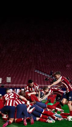 a group of soccer players huddle together on the field