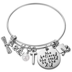 a silver bang bracelet with charms on it and the words, she believed she could't