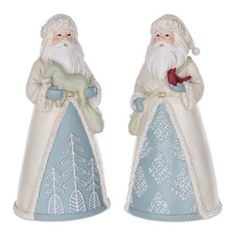 two ceramic figurines of santa claus holding a bird and a deer, one is blue and the other is white