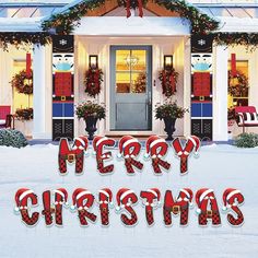 a merry christmas sign in front of a house with holiday decorations on the door and windows