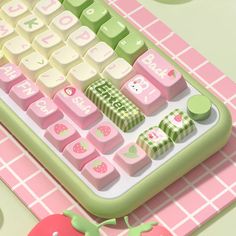 a computer keyboard sitting on top of a pink and green tablecloth covered with fruit