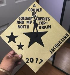 someone is holding up a graduation cap that says, a couple of college credits and my top - brain