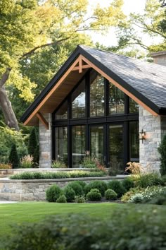 a large house with lots of windows and landscaping