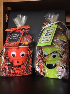 two halloween treat bags sitting on top of a table