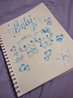 a baby's drawing on a notebook with hearts and teddy bears in blue ink