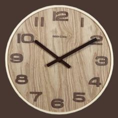 a wooden clock with black numbers on the front and back of it's face