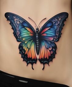 a woman's stomach with a butterfly tattoo on it