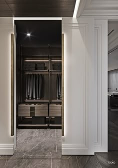 an empty walk in closet with marble flooring