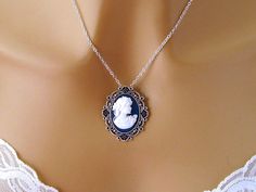 "Navy Blue Cameo: Victorian Woman Blue Cameo Necklace/Antiqued Silver/Vintage Inspired Victorian Cameo Jewelry/Blue Cameo Necklace Romantic Cameo Necklace with beautifully detailed white woman with a rose on a navy blue background and antiqued silvertone setting. The sterling silver fill chain closes with a lobster clasp. Also available with a silver plated brass chain. Length: Choose 16, 18, or 20 inches Pendant: 1.4 inches x 1.25 inches, Cameo 25 x 18 mm Arrives with a Marty White card in a lo Blue Cameo Jewelry For Formal Occasions, Blue Cameo Jewelry For Wedding, Blue Victorian Pendant Necklace, Blue Cameo Necklace, Victorian Cameo Silver Necklace, Victorian Cameo, White Woman, Lace Ring, Cameo Ring