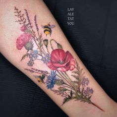 a woman's arm with flowers and a bee on it