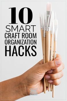 a hand holding up some wooden sticks with the words 10 smart craft room organization hacks