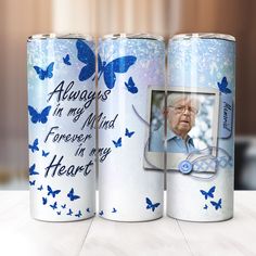 two personalized aluminum cans with blue butterflies on them, one has a photo and the other says always in my mind forever in my heart