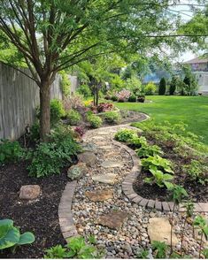 a stone path in the middle of a garden