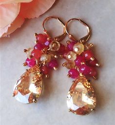 "Elegant, opulent, and shimmery These fabulous vintage inspired earrings can be worn in many occasions. The classic style make these earrings timeless. This brilliant classic earrings features Swarovski blush Champagne crystal teardrop. Crystals are set on a secure prong settings, made of brass and plated in 18 karat gold. Accented with cluster of small cherry quartz, hot pink jade and citrine gemstones. Hanging from a surgical steel lever-back, it measures 1.75\" in length. Earrings are light w Vintage Inspired Earrings, Hot Pink Roses, Cluster Bracelets, Classic Earrings, Pearl Cluster, Pink Agate, Diy Clothing, Citrine Gemstone, Cluster Earrings