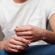 Man's hands with atelium silver bracelet Formal Silver Bracelet With Figaro Chain, Adjustable Figaro Chain Bracelet, Silver Luxury Figaro Chain Bracelet, White Gold Sterling Silver Figaro Chain Bracelets, Adjustable Silver Figaro Chain Bracelet, 75 Medium, Figaro Chains, Figaro Chain, Silver Chain Bracelet