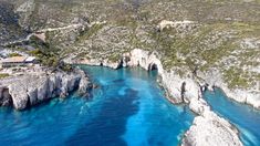 an aerial view of the blue waters and cliffs