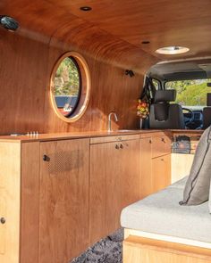 the inside of a vehicle with wood paneling and round mirrors on the side wall