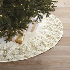 a christmas tree skirt with presents under it