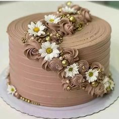 a chocolate cake decorated with flowers and pearls