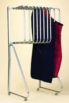 an ironing rack with clothes hanging on it