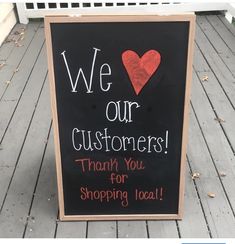 a sign that says we love our customers thank you for shopping local on the porch