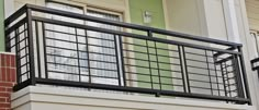 the balcony railing is made of metal and has glass panels on each balconies