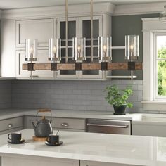 a kitchen with white cabinets and gray walls