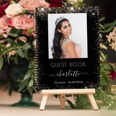 a black and gold guest book with an image of a woman in a tiara