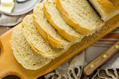 slices of white bread sitting on top of a cutting board