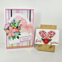 two greeting cards, one with a heart and the other with flowers on it's side