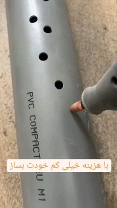 a close up of a baseball bat with holes in the bottom and an inscription on it