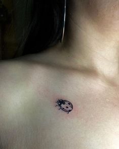 a ladybug tattoo on the chest