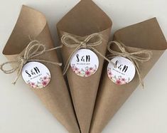 three brown paper cones tied together with twine and some tags on the top one