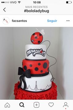 a red and white cake with ladybug decorations on it's top tier