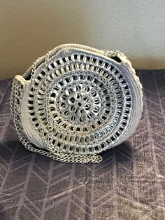 CBPursesBoutique makes handmade soda/pop tab bags.  Each bag has closures and linings.  Bags come in a variety of styles, sizes, and colors.  Each bag is one of a kind and the item pictured for each listing is the item for sale. This bag is a circular evening bag made with soda tabs and grey cotton yarn, with a black fabric lining, linked chain, and snap enclosure. Handmade Silver Bag For Everyday Use, Handmade Silver Bags For Everyday Use, Silver Handmade Bag For Everyday Use, Handmade Silver Shoulder Bag For Everyday Use, Silver Handmade Shoulder Bag For Everyday Use, Soda Tabs, Pop Tabs, Bag Silver, Soda Pop