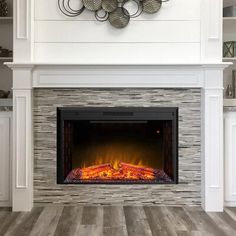 a white fireplace with an electric fire in it