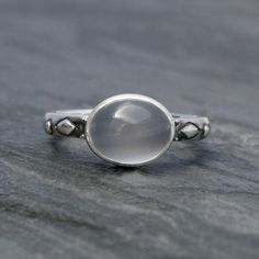 Luminous oval moonstone set in solid sterling silver on a solid sterling silver ring band.Cat eye moonstone gemstone is approximately 3/8" x 1/4" Modern moonstone is a birthstone for June. It's associated with the zodiac sign of Gemini. Moonstone is thought to bring good luck and fortune.This ring will be made to order in your size. Please select your size from the drop down menu.For more rings:https://www.etsy.com/shop/KiraFerrer?ref=hdr_shop_menu&section_id=5254786To see my entire collecti Aquamarine Stacking Ring, Silversmith Rings, Silver Ring Band, Moonstone Ring Sterling Silver, Sterling Silver Stacking Rings, Silver Post Earrings, Sterling Silver Rings Bands, Silver Stacking Rings, Silver Work