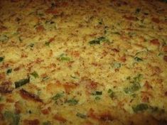 a close up view of a casserole with cheese and green peppers on it