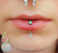 an image of a woman with piercings on her nose and lip ring in the shape of a turtle