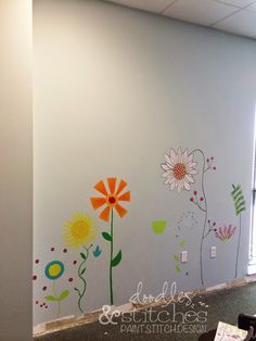 an office wall with flowers painted on it