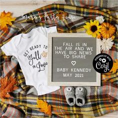 some baby items are laid out on a plaid blanket with the words fall is in the air and news have big share