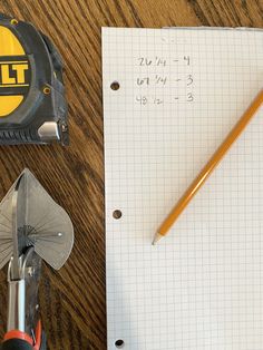 a piece of paper with a pencil on top of it next to a pair of scissors