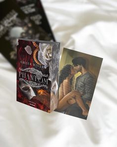 two book covers on top of a bed with white sheets and an image of a man kissing a woman