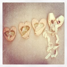 four pairs of ballet shoes are laying on the floor