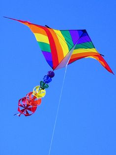 a colorful kite flying in the blue sky