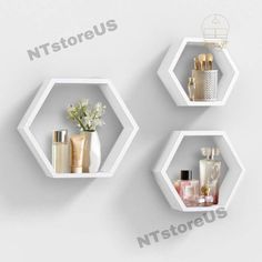 three white hexagonal shelves with different items on them