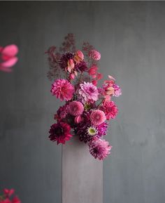 a vase filled with pink and purple flowers