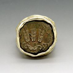 an ancient coin with two hands on it